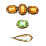 Two late 19th century paste brooches and a citrine pendant. To include a brooch, the oval-shape