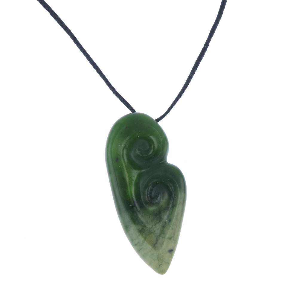 A carved New Zealand jade double Koru pendant by Paddy Cooper. The Koru representing an unfurling