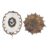 Two late Victorian brooches. The first of oval-outline with scalloped surround to the white