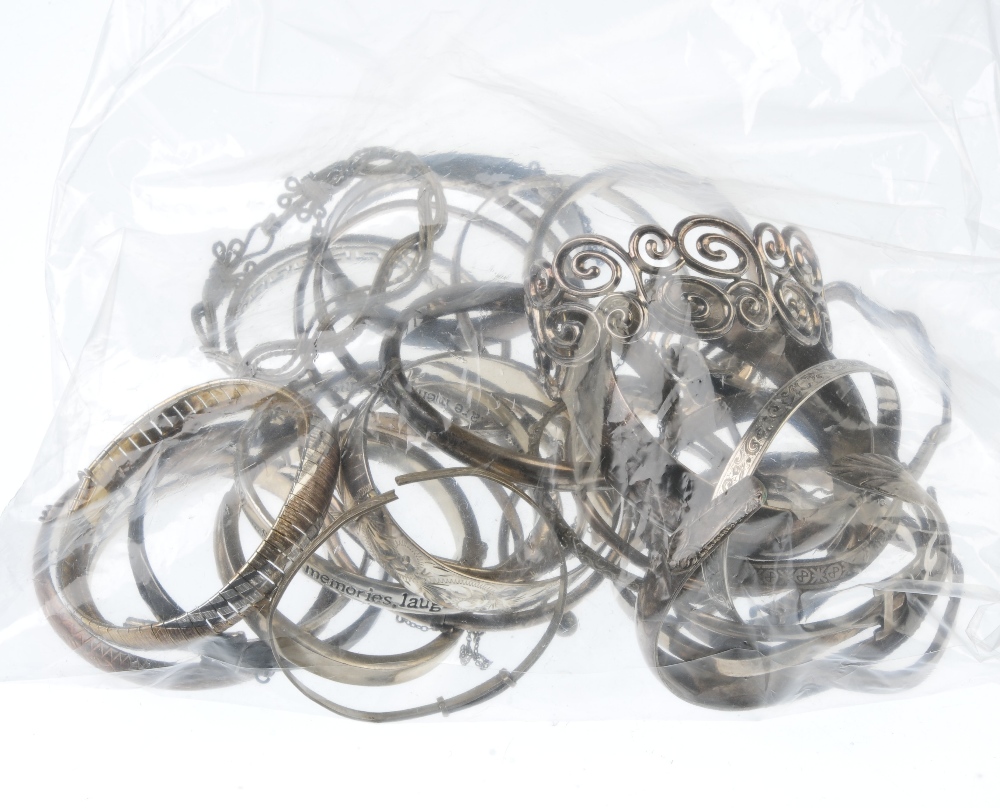 A selection of silver and white metal bangles. To include a square profile bangle, a hinged silver - Image 2 of 2