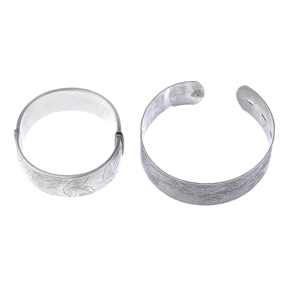 Two silver bangles. To include a 1940s silver floral embossed bangle and a 1960s silver foliate