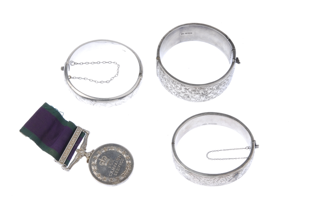 Three hinged silver bracelets and a medal. Two hinged bracelets with acanthus engraving, one to - Image 2 of 2