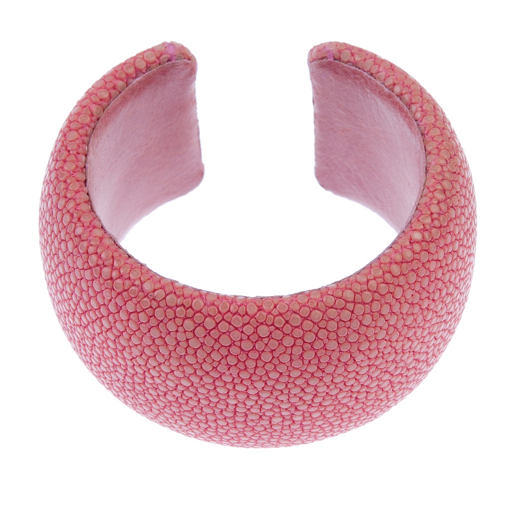 A pink stingray cuff. The salmon pink stingray cuff with pink leather lining signed Maximos. Inner