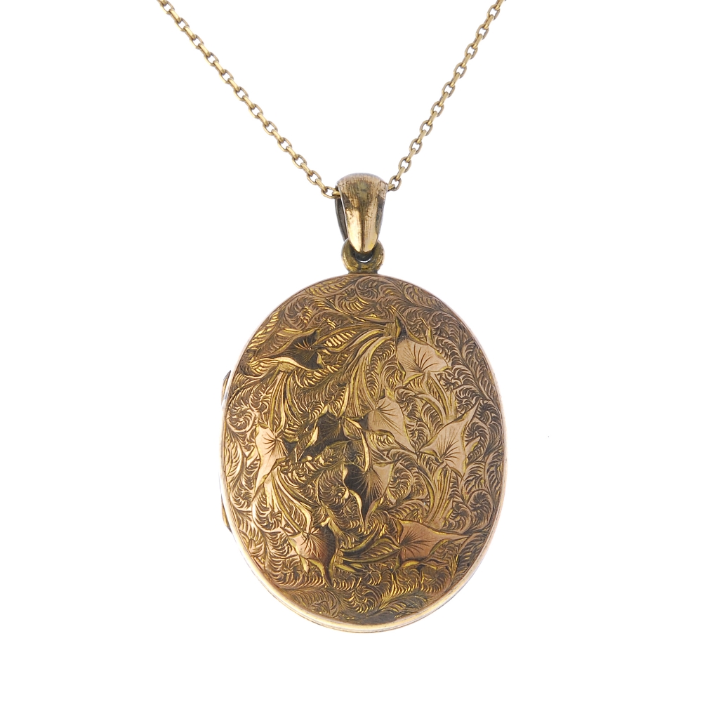 A gold front and back locket. Of oval-outline, the front and back with ivy engraving, opening to