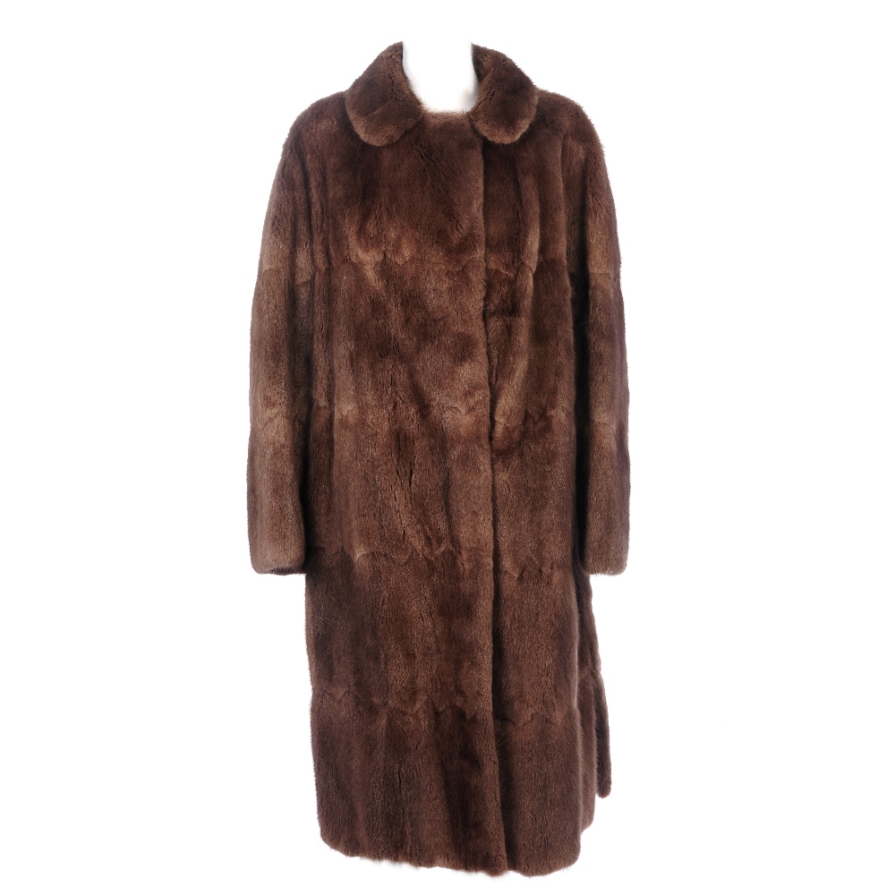 A full-length musquash coat. With a notched lapel collar, hook and eye fastenings, side vents,