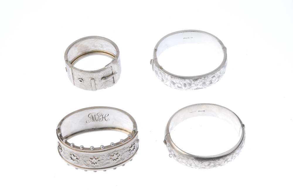 Three silver bangles and a napkin ring. To include one with applied stars and foliate engraving to - Image 2 of 2