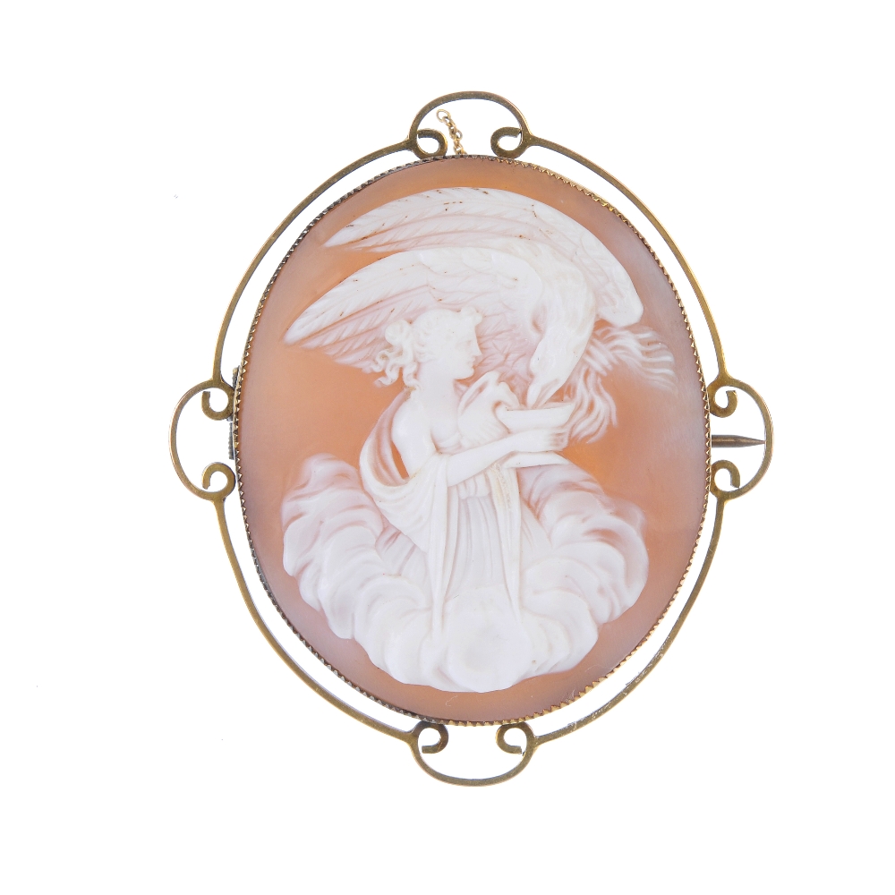 A shell cameo brooch depicting Hebe and Zeus. Hebe feeding Zeus, in the form of an eagle, from a