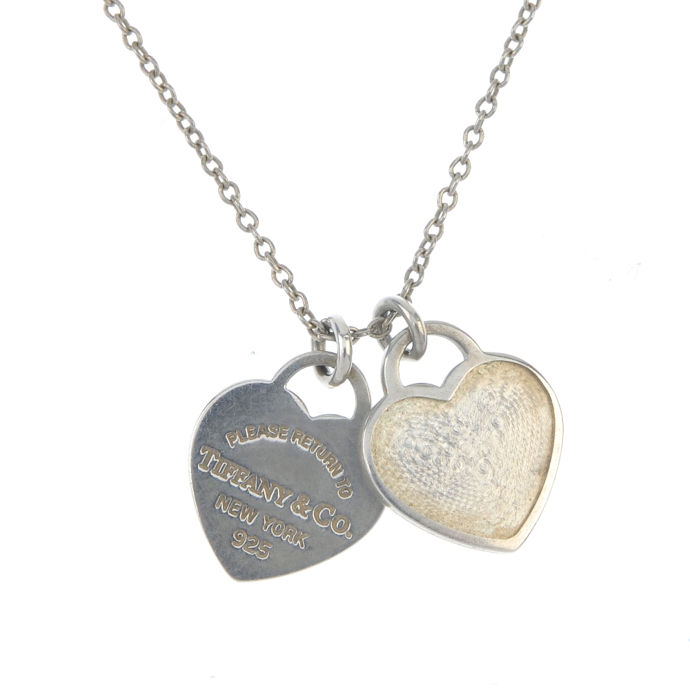 TIFFANY & CO. - a pendant. Designed as a chain, suspending two small heart charms, one reading '