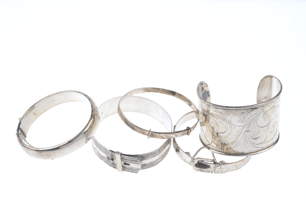 A selection of silver and white metal bangles. To include a scroll engraved cuff, a 1950s silver - Image 2 of 2