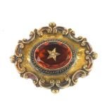 A late Victorian gold brooch. The central oval-shape citrine with star set with split pearl to its