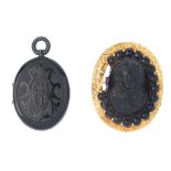 A late Victorian jet locket and a lava brooch. The locket of oval-outline, with engraved scrolling