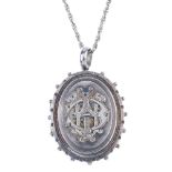 A late Victorian silver locket. The chain suspending a locket of oval outline, with castellated