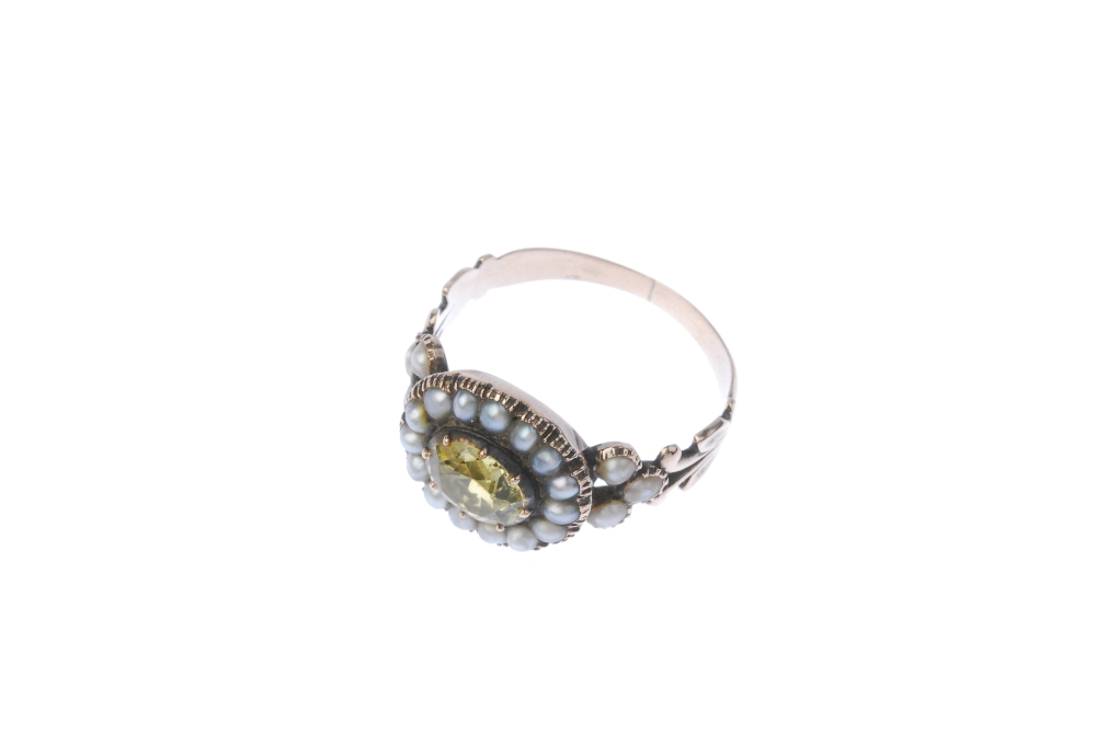 A mid Victorian gold chrysoberyl and split pearl ring. The centrally mounted gold chrysoberyl to the - Image 2 of 3