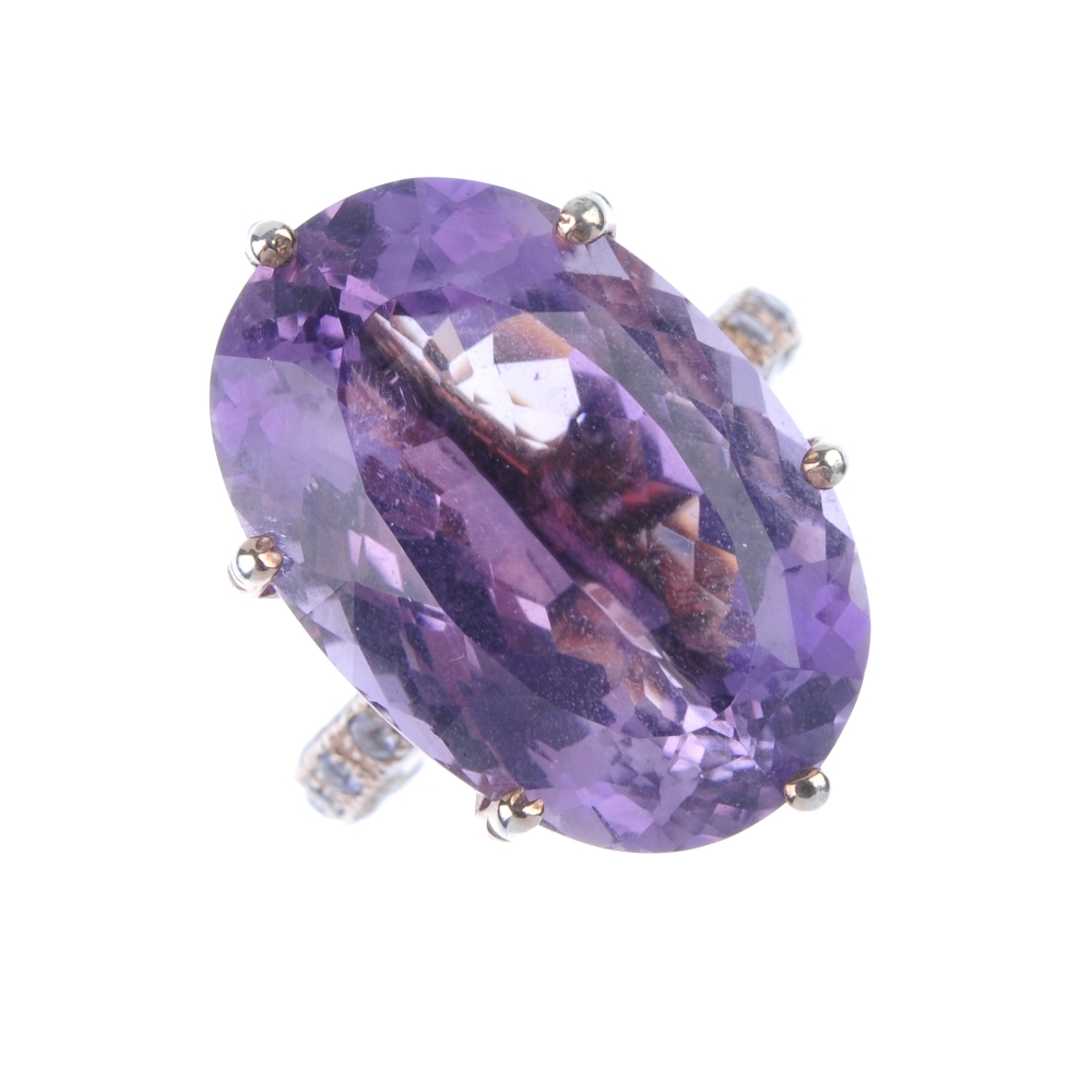 Two items of gem jewellery. The first an amethyst ring, the oval-cut amethyst claw-set to the
