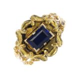 A late Georgian 18ct gold composite ring. The rectangular blue stone to the acanthus surround and