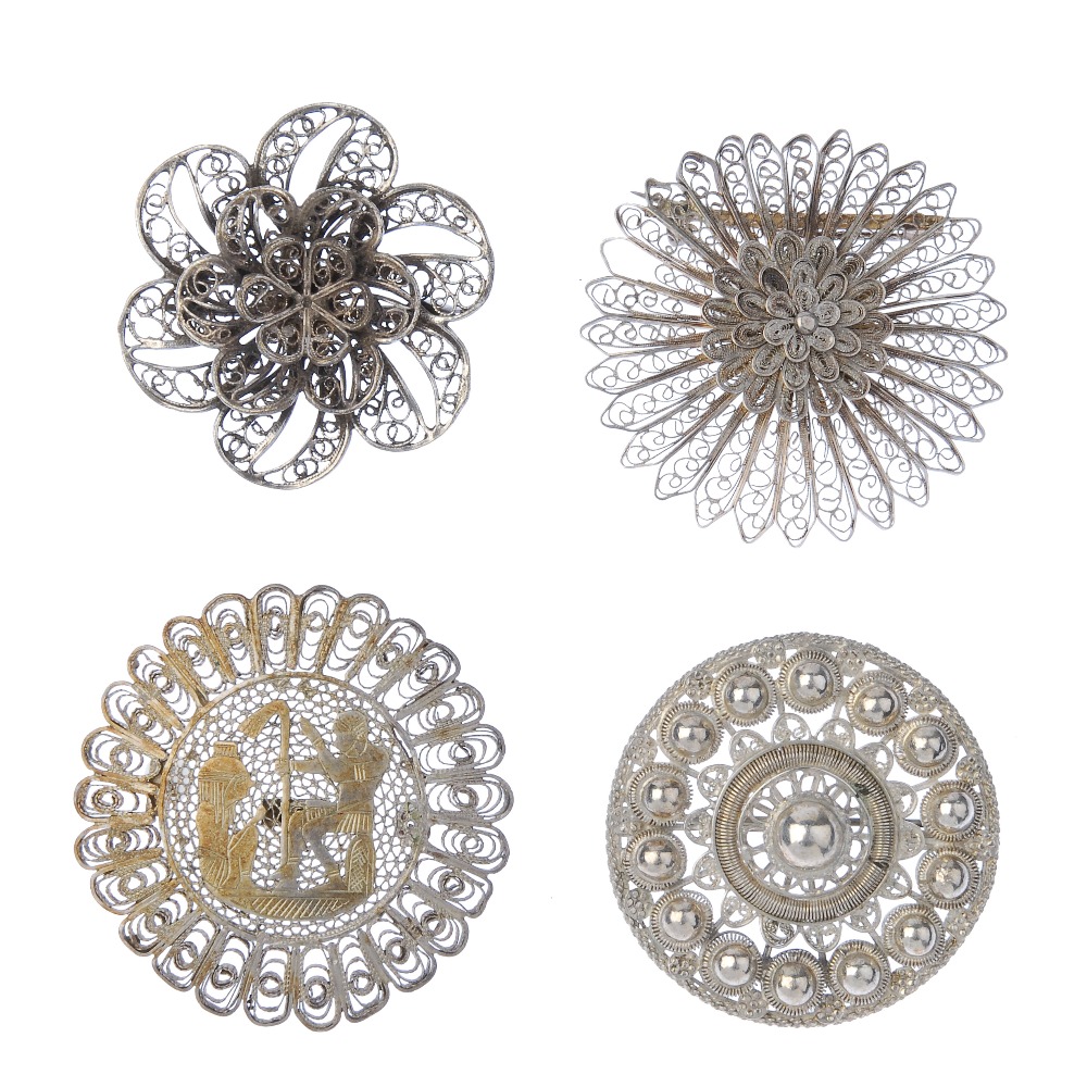 A selection of silver and white metal filigree jewellery. To include a brooch in the shape of two