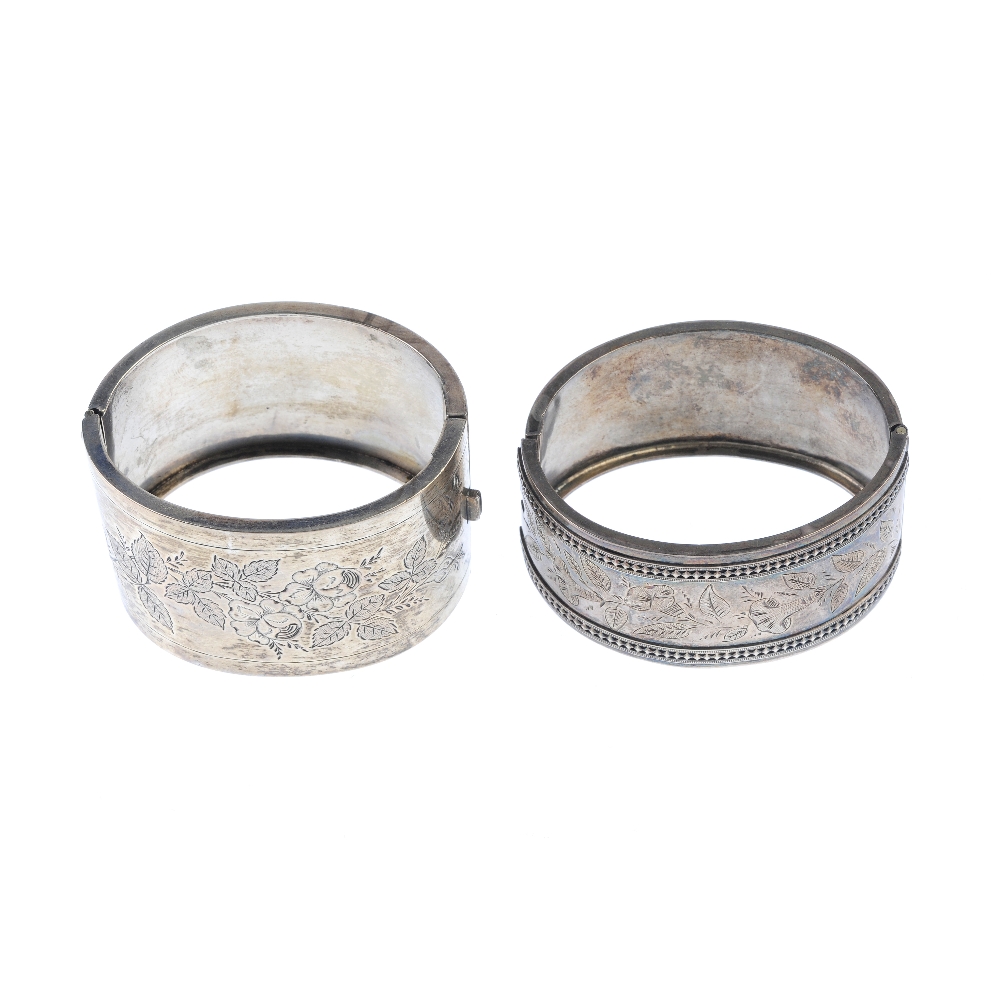 Two late Victorian silver hinged bangles. Each designed with foliate embossed detail. One with