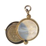 Three items of late 19th to early 20th century jewellery. To include an oval-shape locket, with