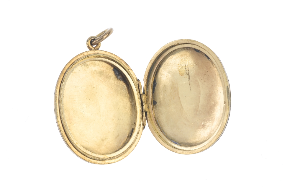 A late Victorian locket. The gold front and back locket is of oval outline with engine turned - Image 3 of 3