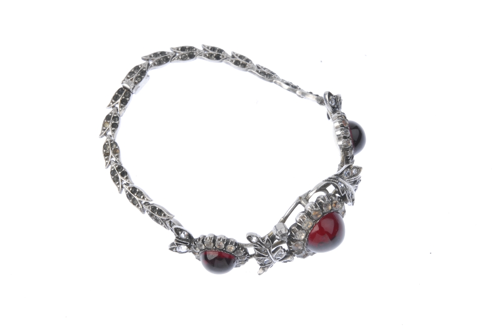 An early 20th century paste bracelet. Designed as three red paste cabochons with colourless paste - Image 3 of 3