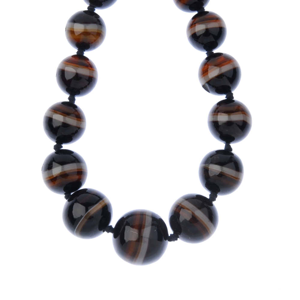 An agate bead necklace. Comprising a series of twenty-three graduated spherical beads, to the