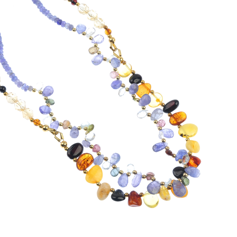 A tanzanite and multi-gem necklace and a natural and reconstructed amber and citrine necklace. The
