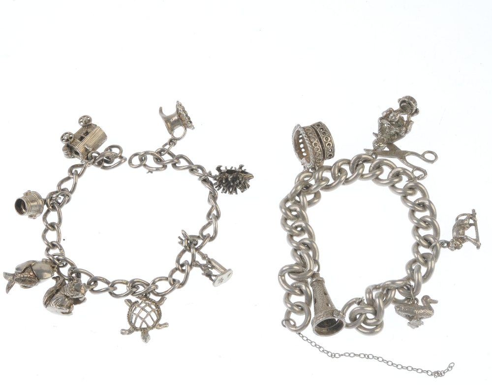 Two charm bracelets. Both designed as curb-link chains, suspending a total of fourteen charms, to - Image 2 of 2