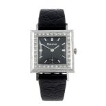 BULOVA - a wrist watch. White metal case with white stone set bezel, stamped 14kt. Numbered