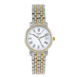 TISSOT - a lady's bracelet watch. Stainless steel case with gold plated bezel. Reference T825/925,