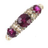 An Edwardian 18ct gold ruby three-stone and diamond ring. The graduated circular-shape ruby line,