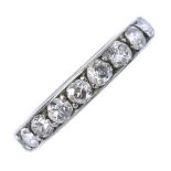 An early 20th century diamond full-circle eternity ring. The old-cut diamond line, to the engraved
