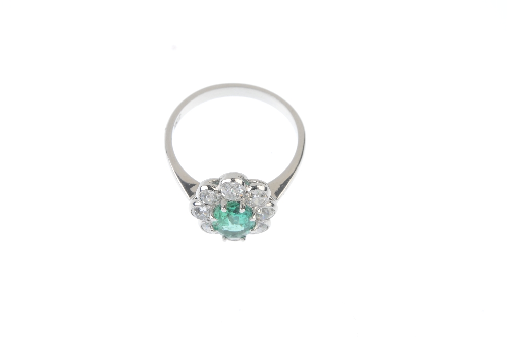 Emerald and diamond floral cluster ring. The oval-shape emerald, within an old-cut diamond scalloped - Image 2 of 3