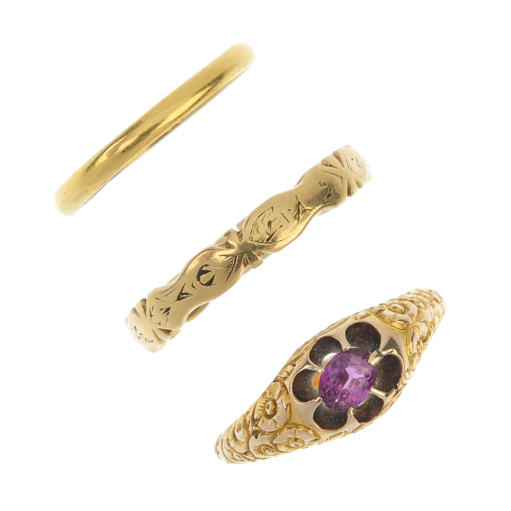 A selection of three rings. To include an oval-shape garnet single-stone ring with floral motif