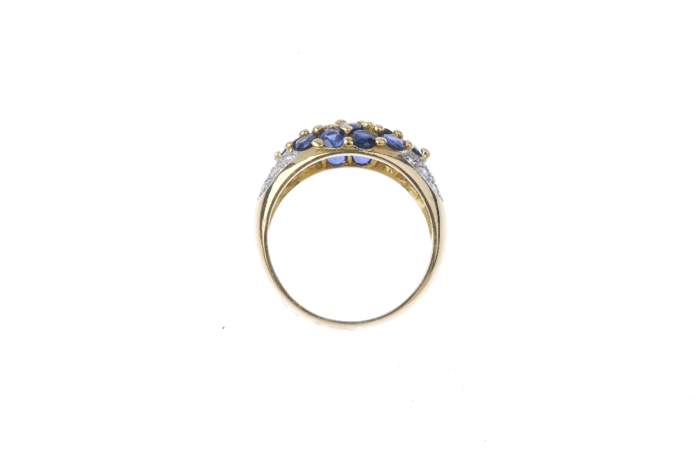 A sapphire and diamond ring. The circular-shape sapphire marquise-shape panel, to the pave-set - Image 3 of 3