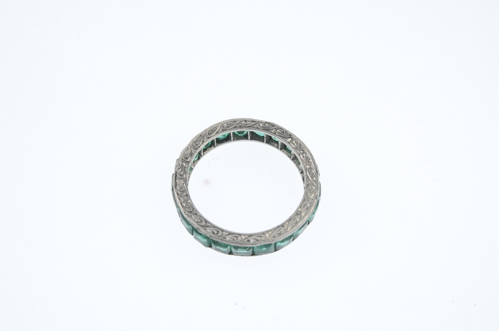 An emerald full-circle eternity ring. The square-shape emerald line, with scrolling engraved - Image 3 of 3