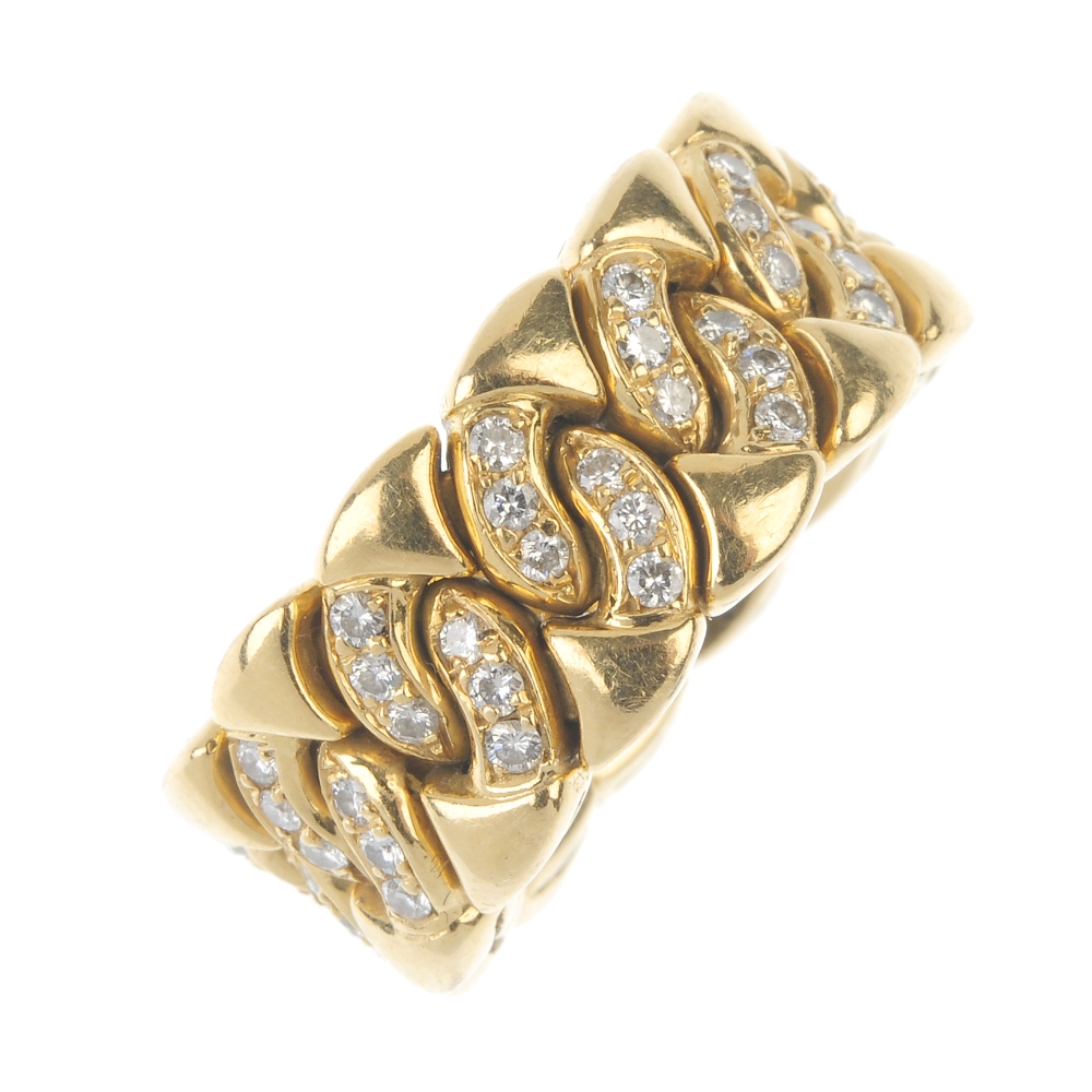 BULGARI - an 18ct gold diamond ring. Of flexible design, the brilliant-cut diamond, circular-shape