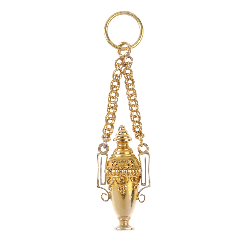 A late Victorian gold Etruscan revival pendant. The cannetille urn, with removable screw thread top,