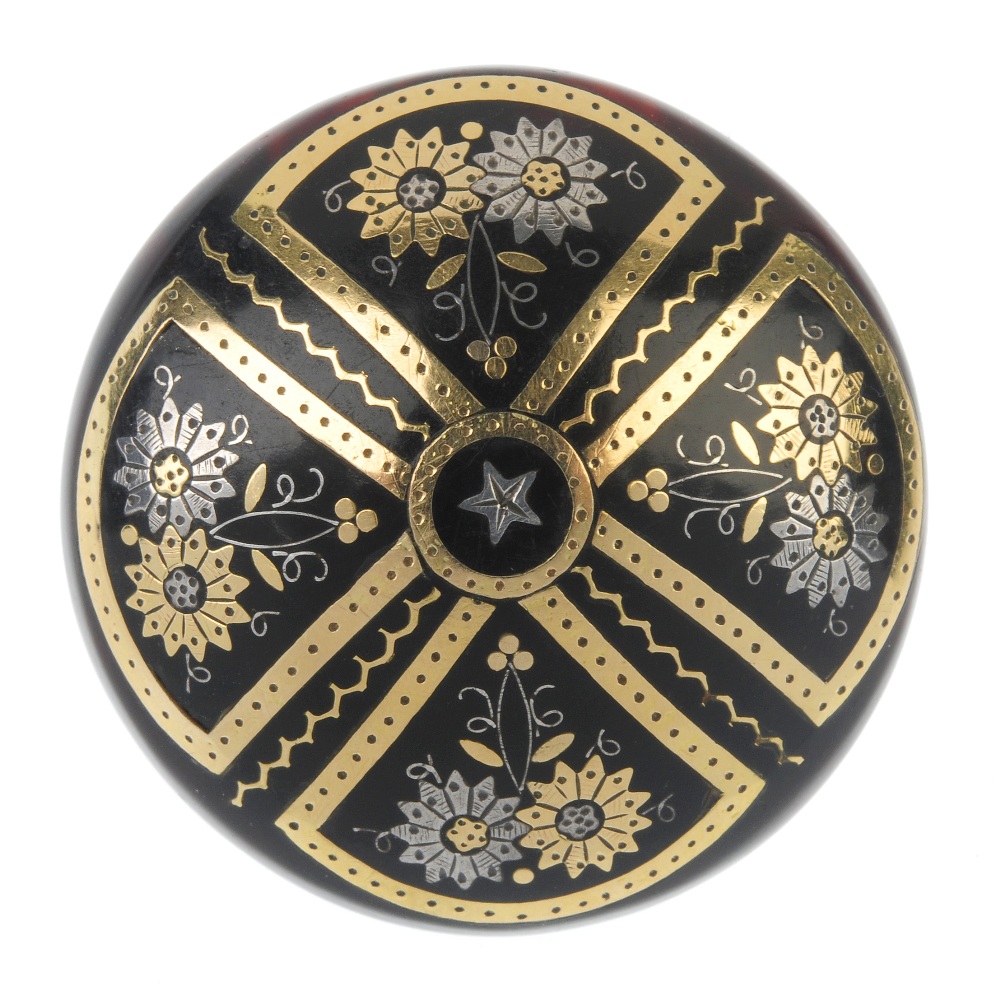 A late 19th century pique tortoiseshell brooch. The central star accent, within a floral