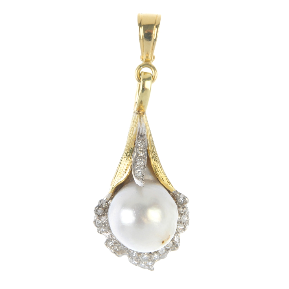 A 1970s cultured pearl and diamond lily pendant. The cultured pearl, measuring 13.4mms, within a