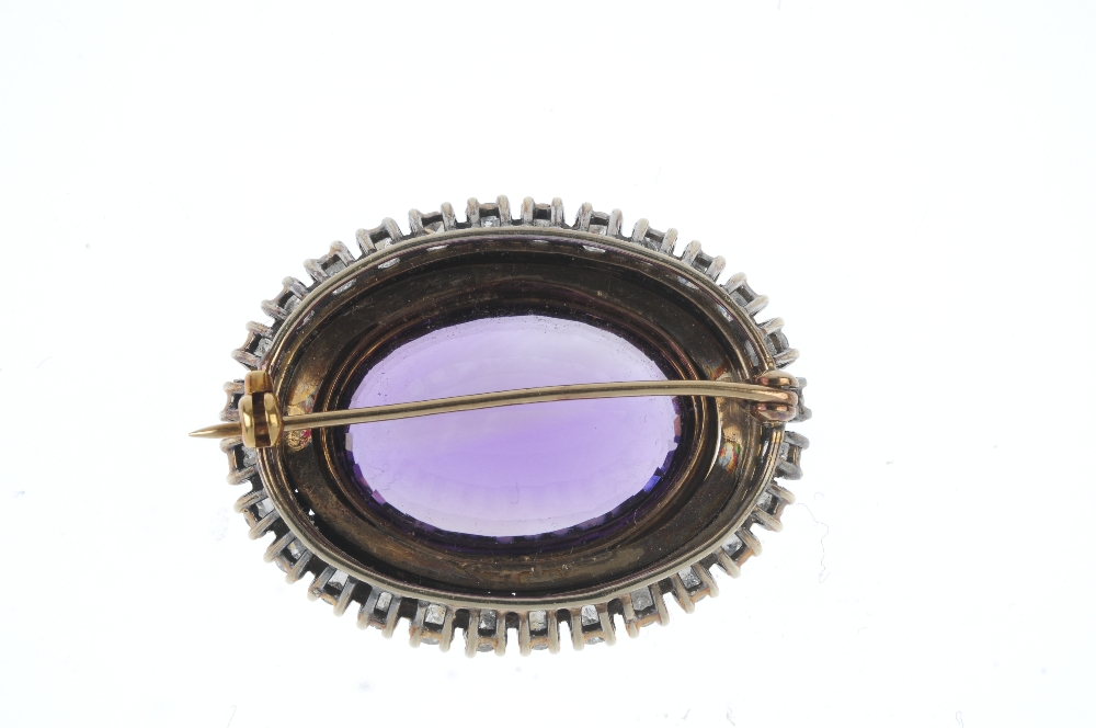 An amethyst and diamond brooch. The oval-shape amethyst collet, within a brilliant-cut diamond - Image 2 of 2