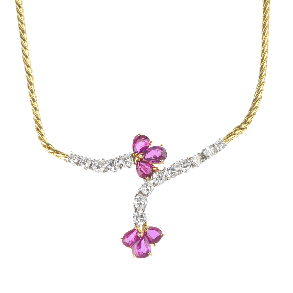 A 1980s 18ct gold ruby and diamond necklace. The front designed as a two pear-shape ruby trefoils,