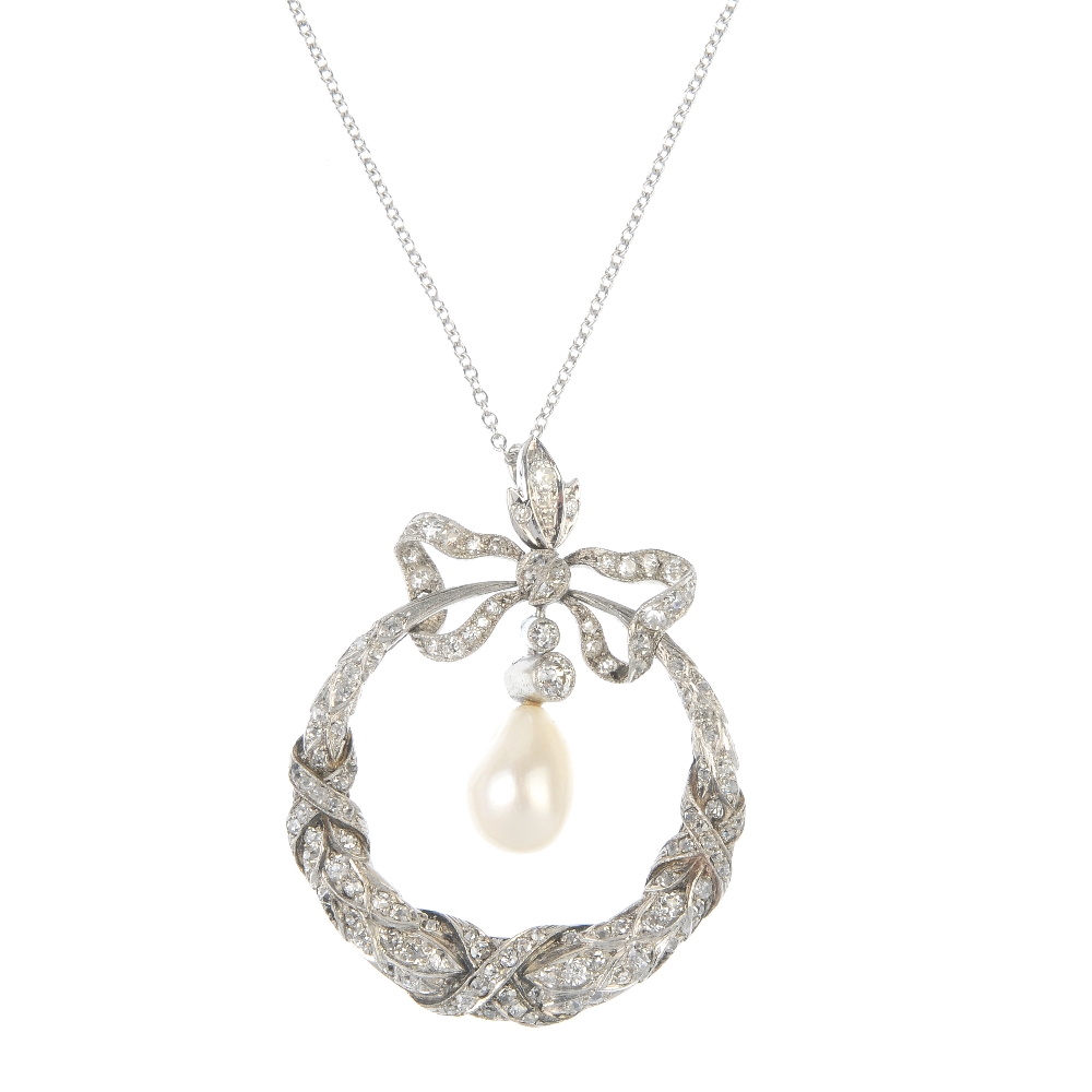 An early 20th platinum century diamond and cultured pearl pendant. The old-cut diamond and