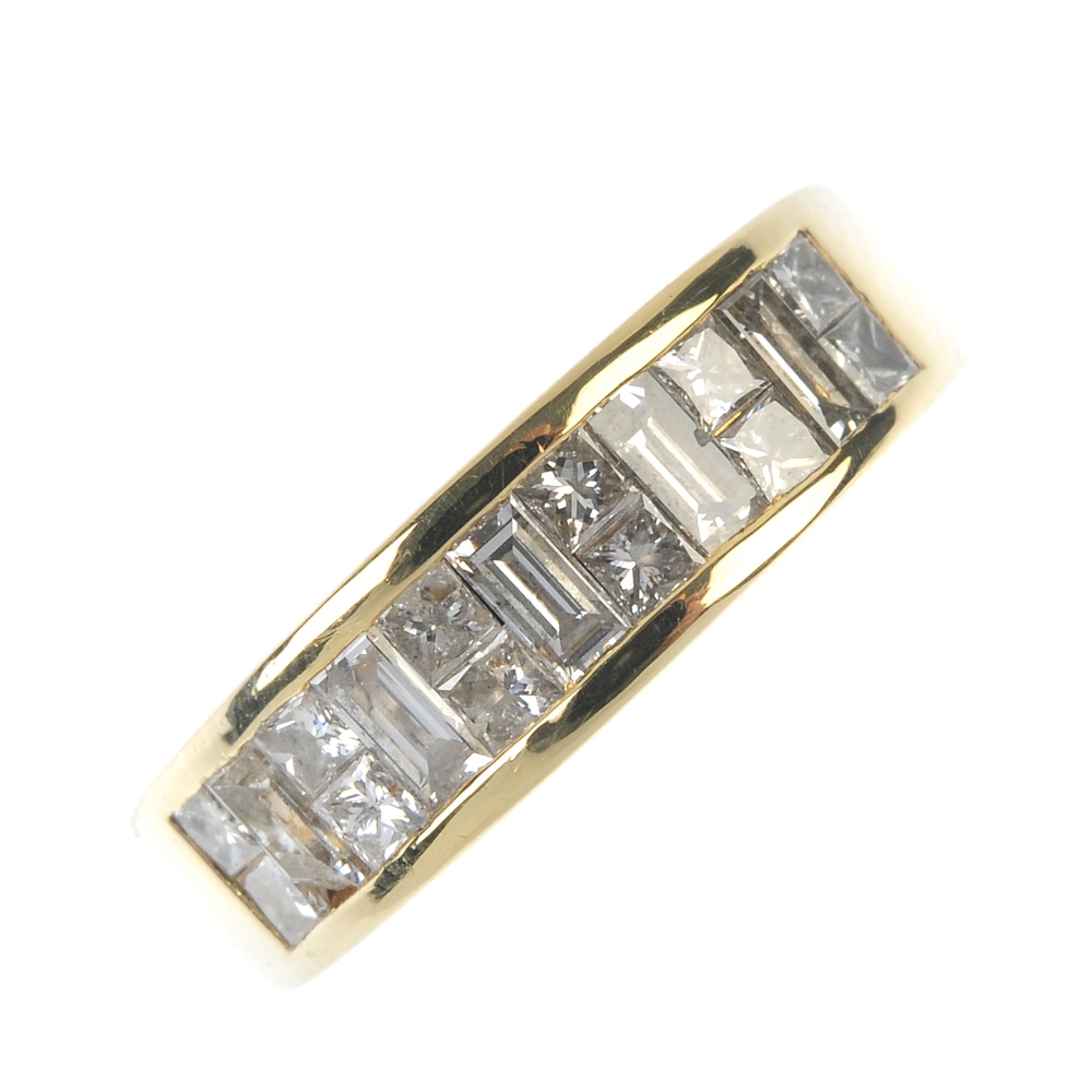 An 18ct gold diamond half-circle eternity ring. Designed as a series of baguette-cut diamonds,