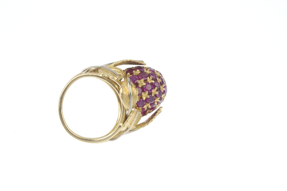 A 1950s 18ct gold ruby dress ring. The pave-set ruby bombe panel, within a bi-colour, textured - Image 3 of 3