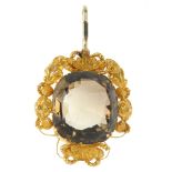 A late 19th century gold citrine pendant. The cushion-shape citrine, within a cannetille surround.