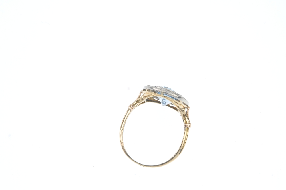 An early 20th century platinum and 18ct gold topaz and diamond cluster ring. The replacement oval- - Image 3 of 3