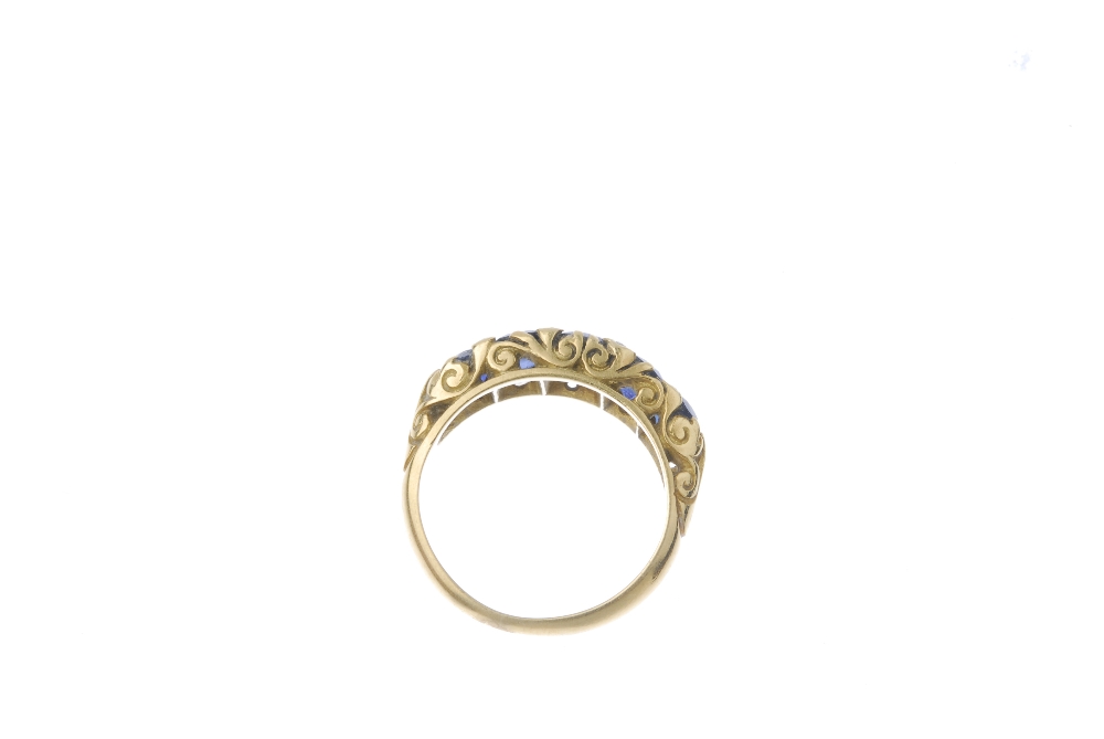 A sapphire and diamond five-stone ring. The vari-shape sapphire graduated line, with diamond point - Image 3 of 3