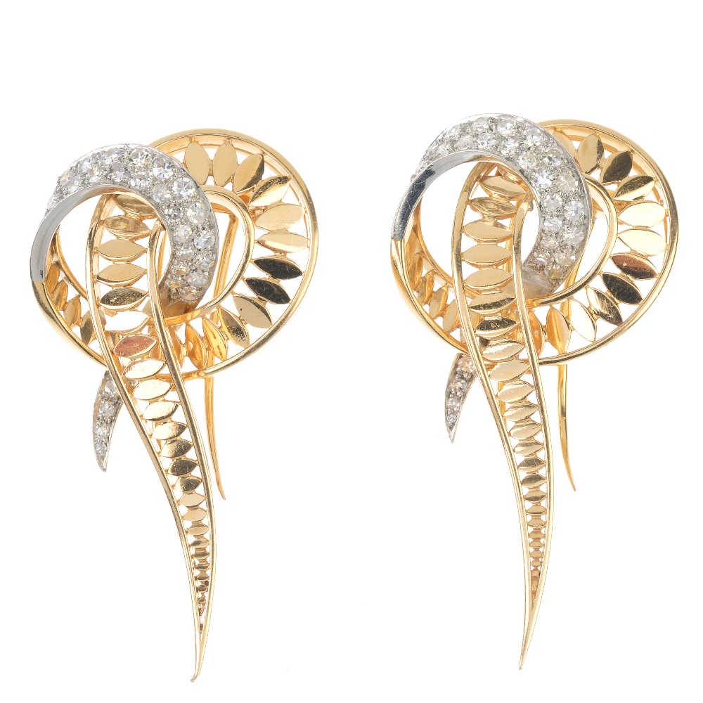 A pair of 1970s diamond clips. Each designed as an openwork stylised knot with pave-set diamond