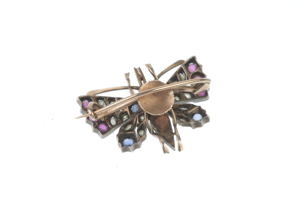 A late 19th century silver and gold diamond, ruby, sapphire and split pearl butterfly brooch. The - Image 2 of 4