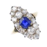 A sapphire and diamond cluster ring. The cushion-shape sapphire, within an old-cut diamond
